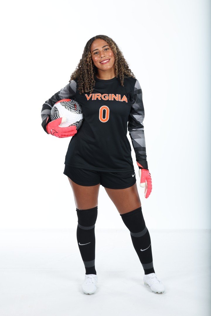 Cayla White in her University of Virginia number zero goalkeeper kit holding a soccer ball.